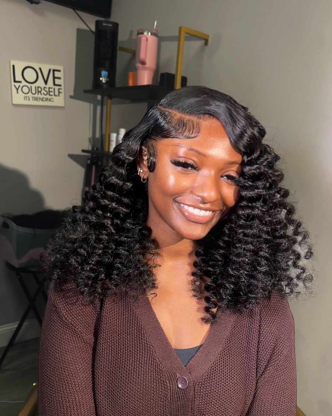 Voluminous curly install with swoop edges
